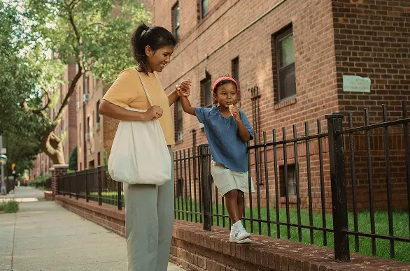 Woman and child walking in a city